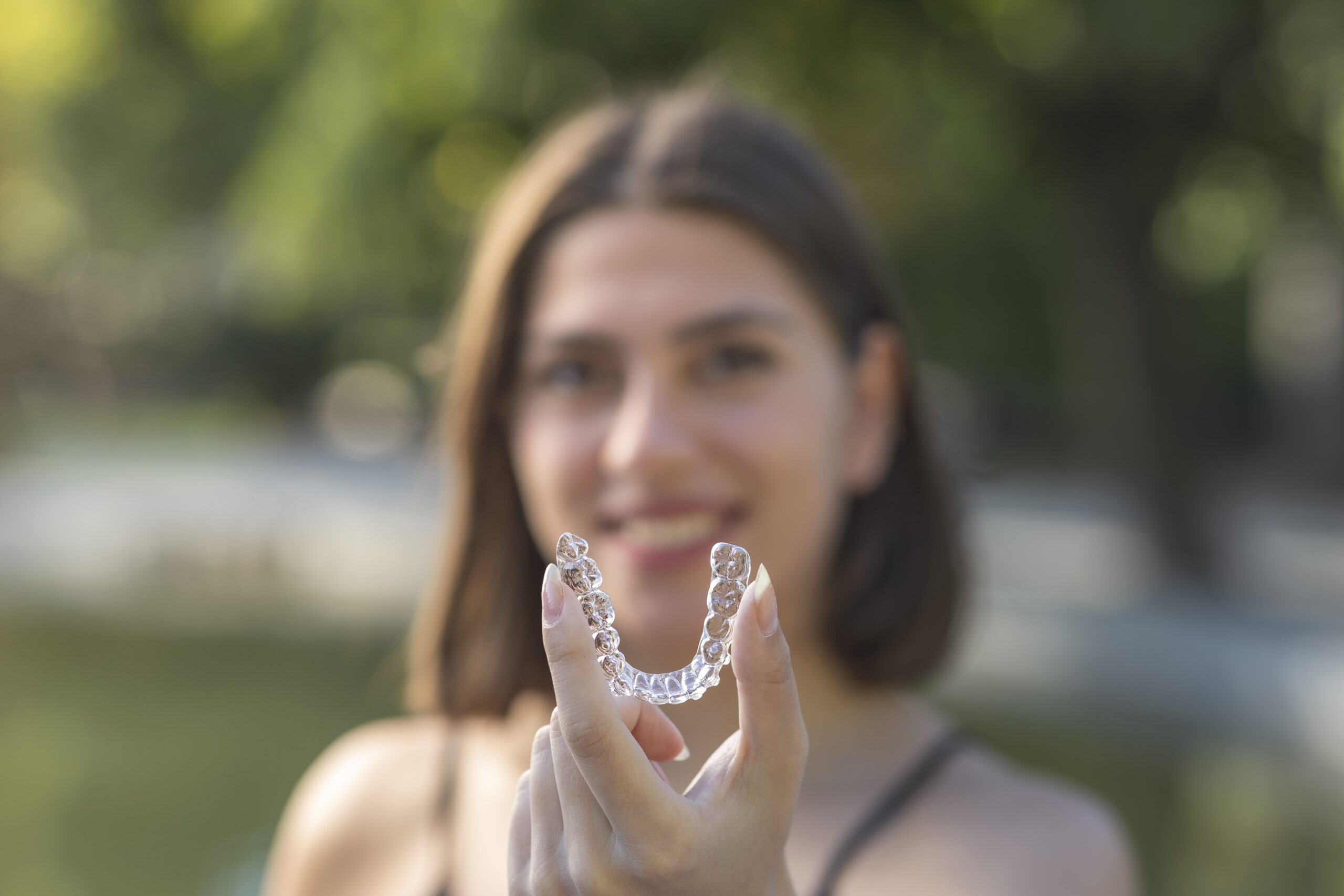 Smiling Woman with aligners